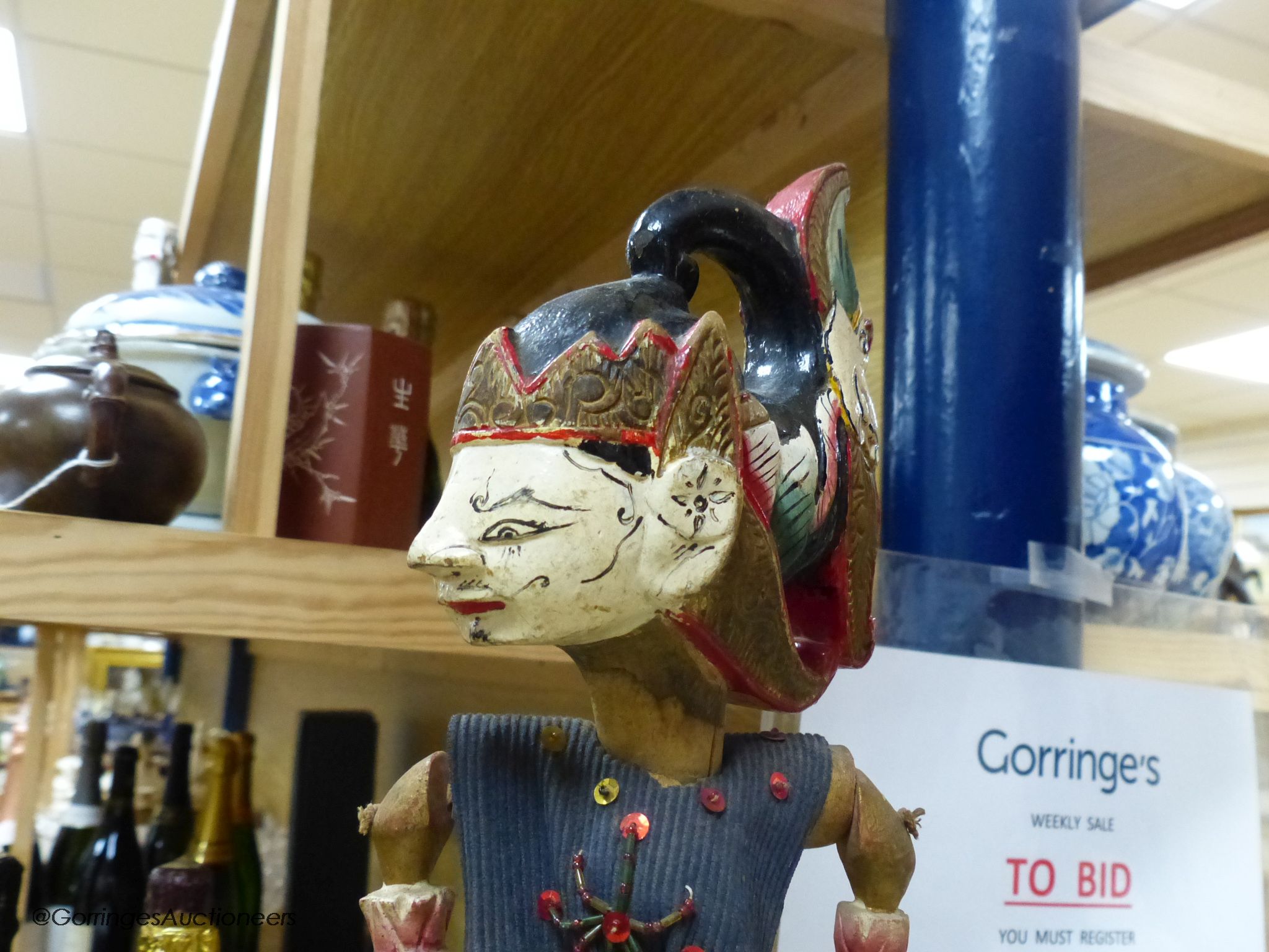 Two Indonesian stick puppets and a book relating to stick puppets, tallest 70cm